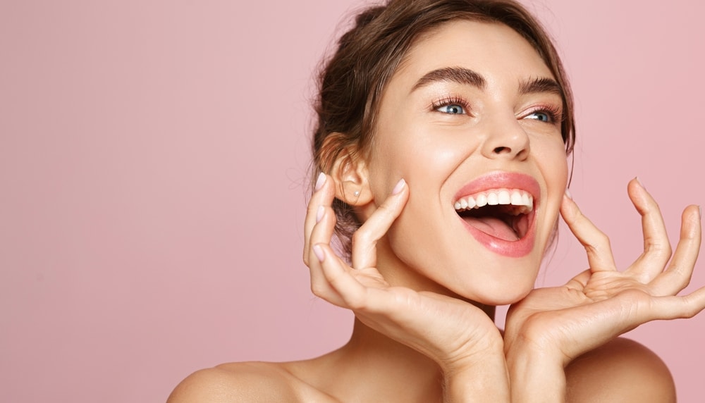 Beautiful woman smiles widely, revealing white teeth after professional teeth whitening in Lebanon